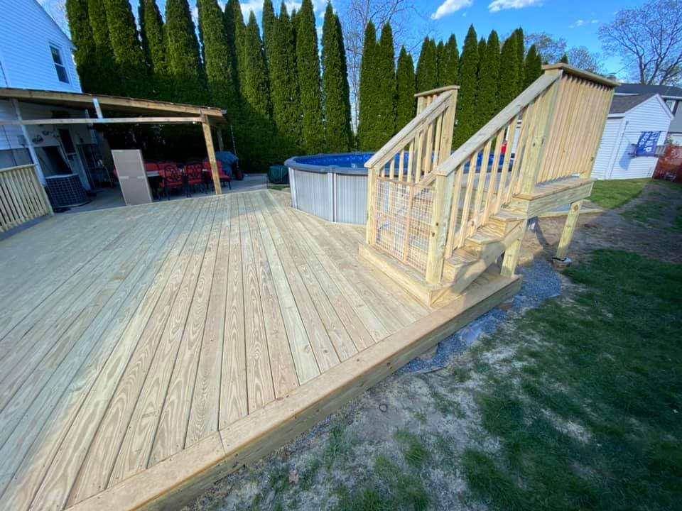 Custom deck and patio for surrounding above ground pool unfinished wood