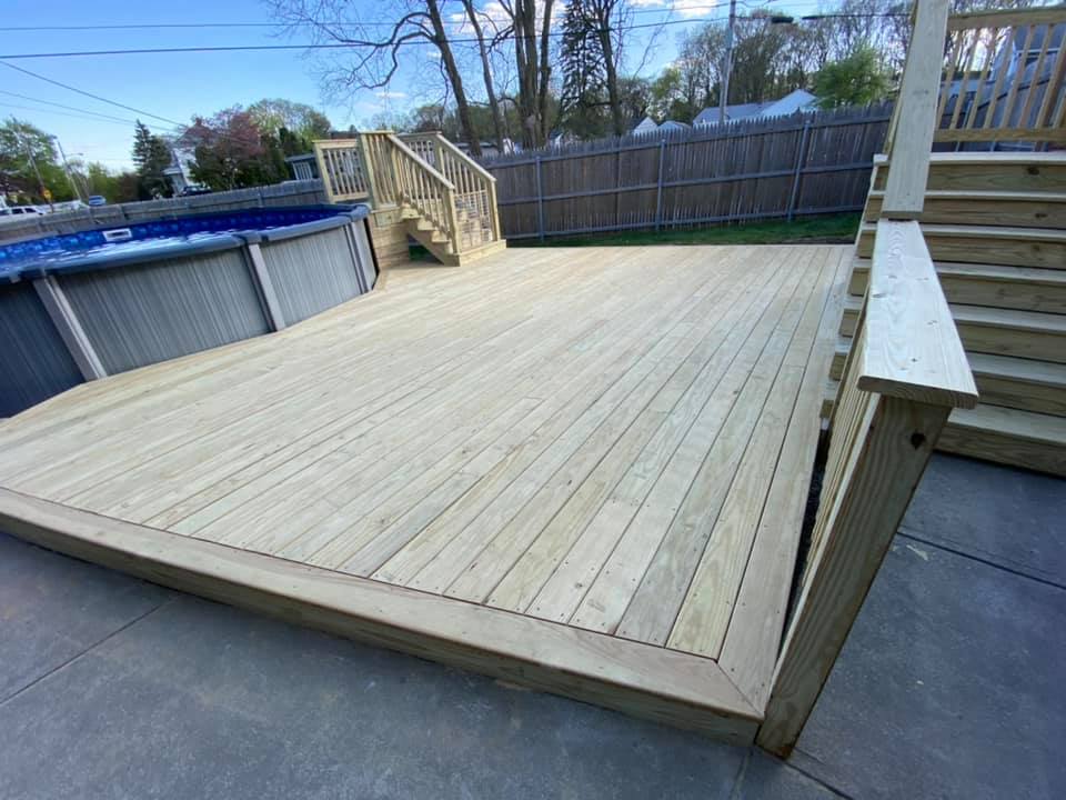 Custom deck and patio for surrounding above ground pool unfinished wood
