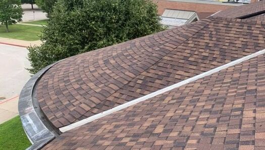 Brown asphalt shingles installed on large rounded roofing